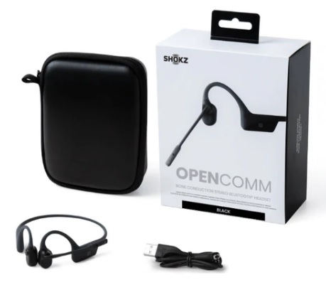 Unboxing of the Shokz OpenComm Delivery Packaging, to reveal an aftershokz opencomm bone conduction headset with a boom mic, 1 usb-c charging cable, and 1 carrying case