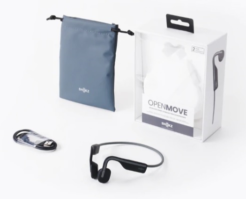 Unboxing of the delivery package for the Aftershokz Openmove headset, showing 1 Openmove headset, 1 carrying bag, 1 usb-c cable, a pair of earplugs and an instruction manual