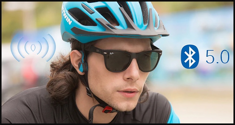a cyclist in full cycling gear and sun shades, listening to music through the vidonn f1 wireless bluetooth v5.0 headphone