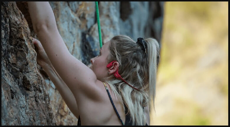 A rock climber wearing bone conduction headphones, enjoying music and staying aware of their surroundings. - Easter Gifts for Tech Lovers