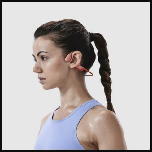 woman wearing shokz openrun pro while exercising
