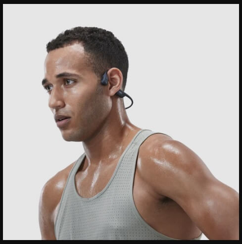 man in sweat top wearing the shokz openrun pro