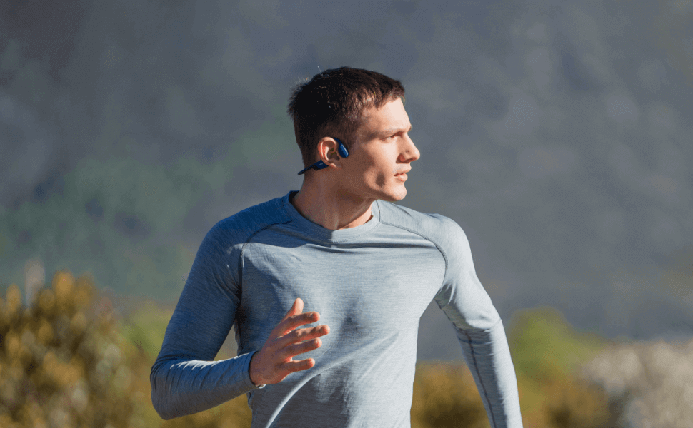 Jogger enjoying outdoor exercise with bone conduction headphones. - budget Bluetooth vs mp3 bone conduction headphones