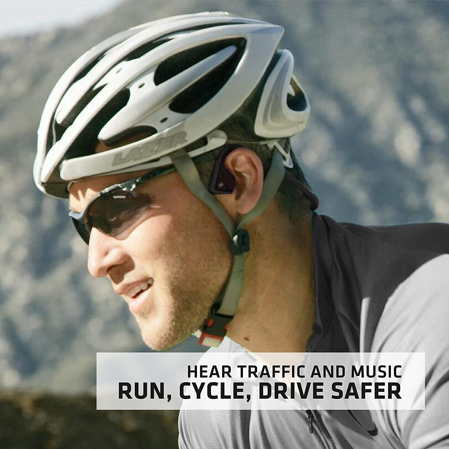 a man cycling outdoors wearing a cycling helmet, cycling googles, and listening to music through the open-ear aftershokz titanium bone conduction headphone as600