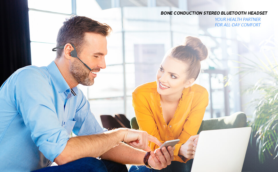 a man in the office teaching his female colleague how the vidonn f3 pro headphone works