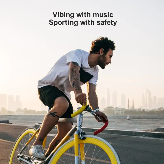 Cyclist wearing wireless bone conduction headphones, enjoying a cable-free listening experience - Wireless vs Wired Budget Bone Conduction Headphones