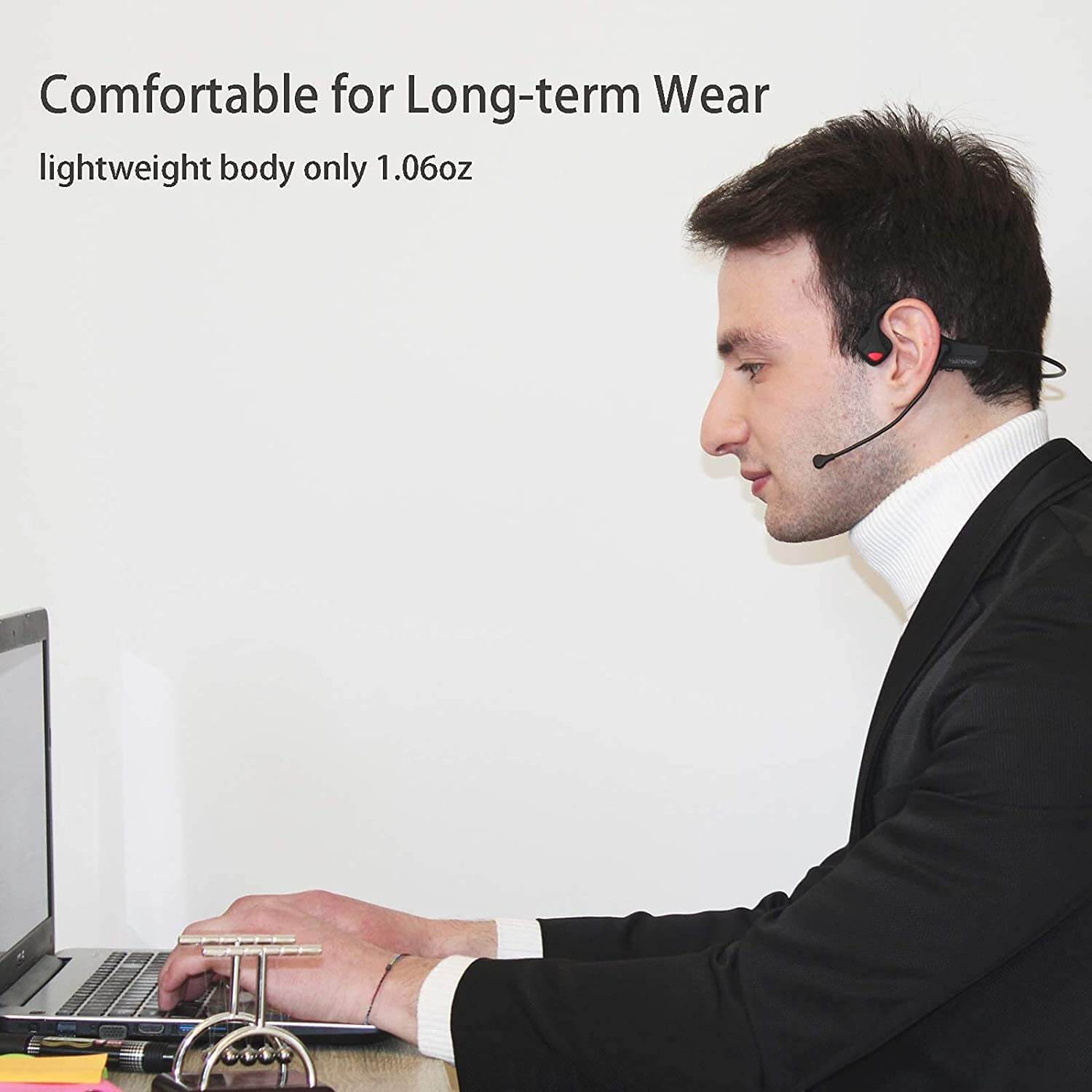 A focused individual uses wireless bone conduction headphones for a comfortable and productive work session.