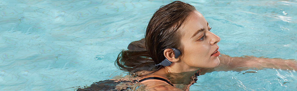 Person wearing bone conduction headphones swimming in the pool - Swimming Bone Conduction Headphones